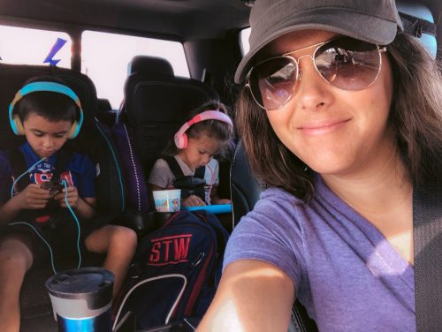 Kids playing tablets in car on headphones
