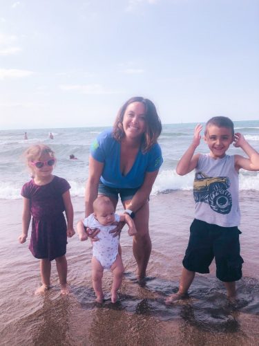 Family standing on beach